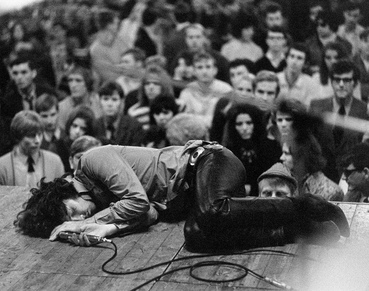 Jim Morrison laying on stage during a performance of The Doors in Frankfurt, Germany. (1968)