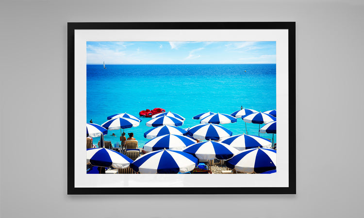 Striped Umbrellas against the Turquoise Water of the French Riveria.