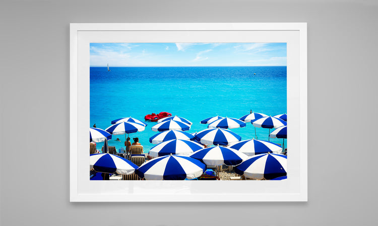 Striped Umbrellas against the Turquoise Water of the French Riveria.