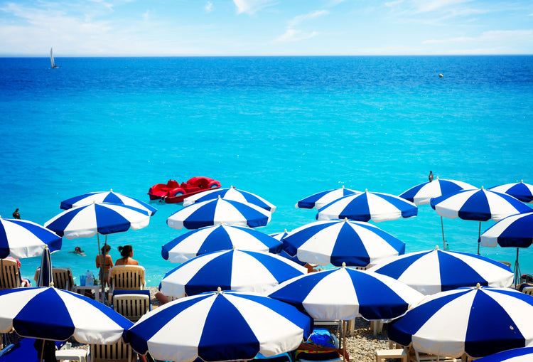 Striped Umbrellas against the Turquoise Water of the French Riveria.